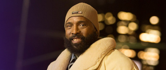 Person wearing puffy yellow coat and brown knit cap.