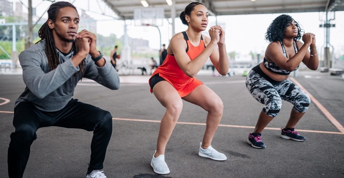 Three young people exercising outdoors.
