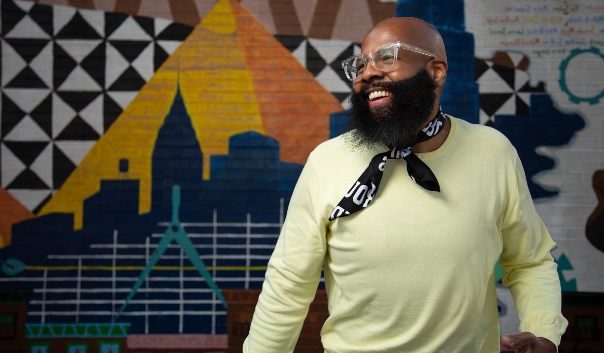 Man in yellow shirt wearing neck kerchief