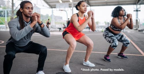 Three young people exercising outdoors.