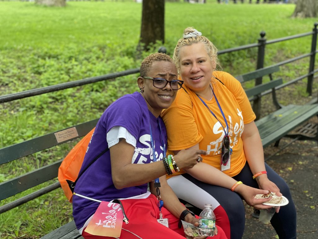 Photo of SelectHealth Outreach representative Chevelle Jones sitting on park bench with colleague during AIDS Walk