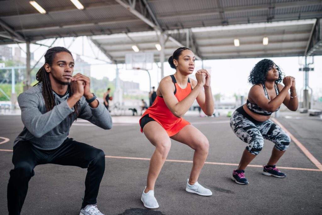 Team of three African American young people exercising outdoors