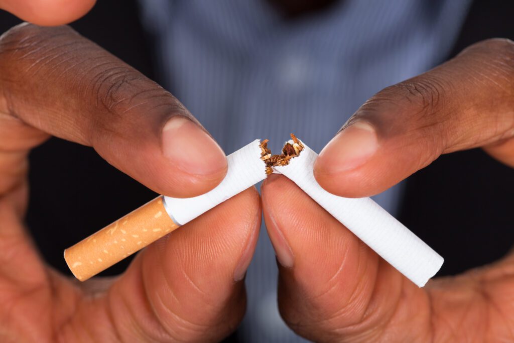 Close-up Of Human Hands Breaking The Cigarette